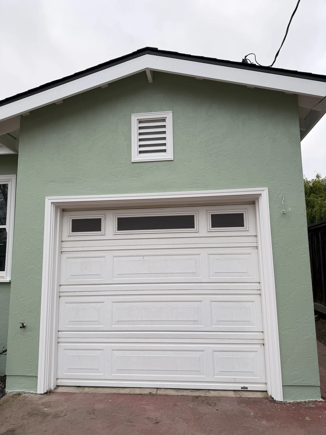 Completed stucco finish around a garage door in San Mateo