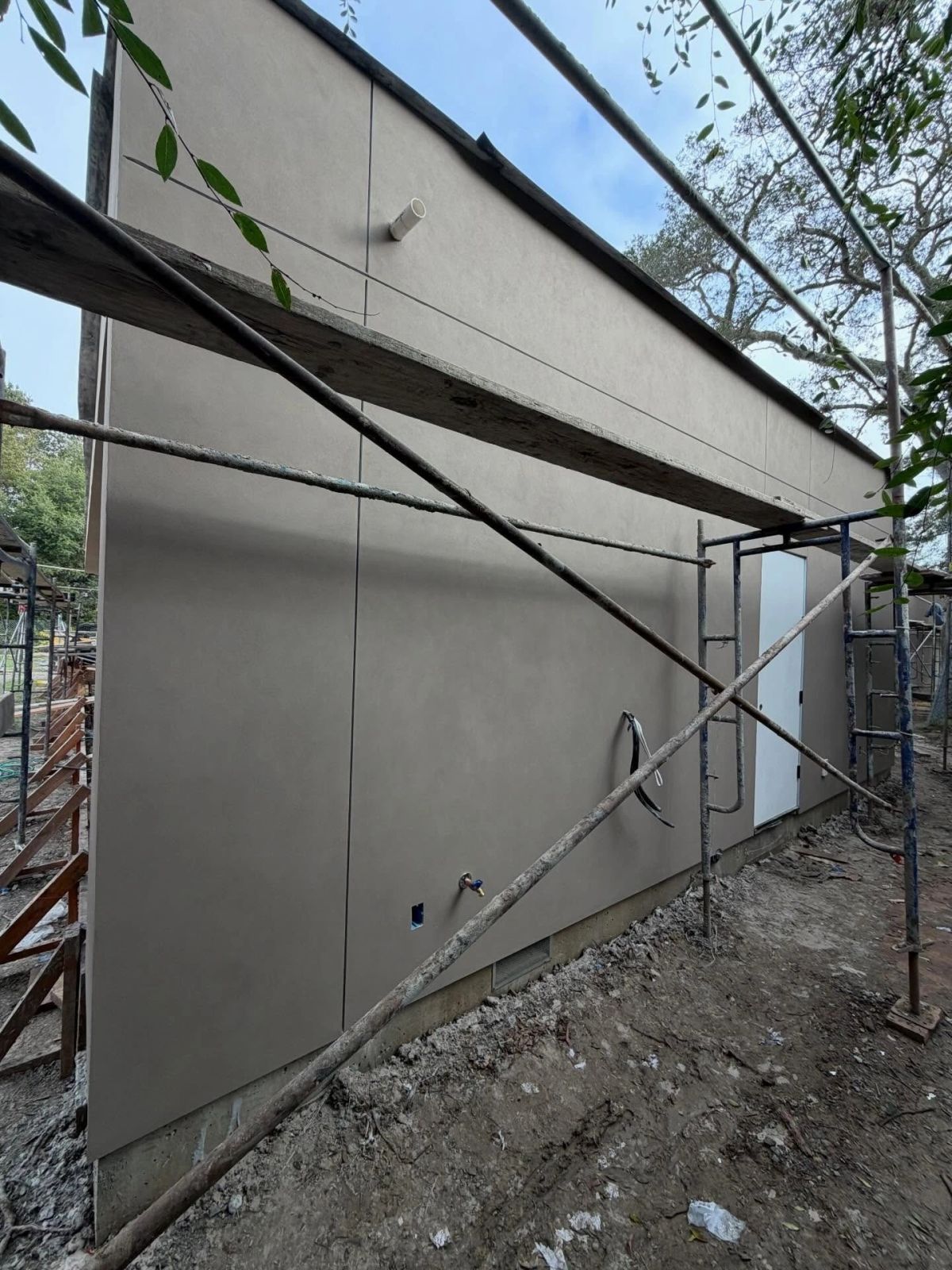 Fresh stucco work underway on a building exterior